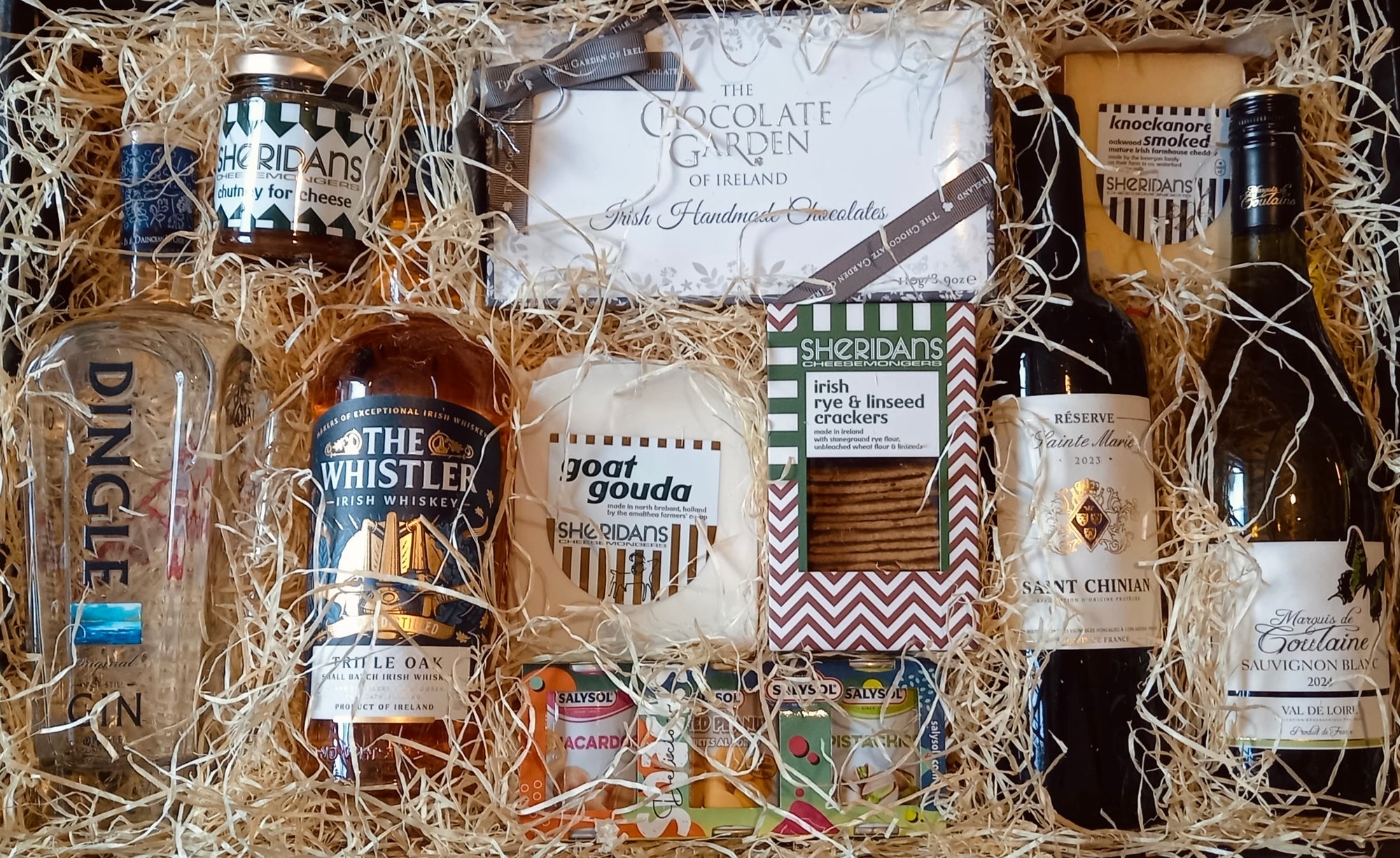 selection of wine, gin, whiskey displayed in a hamper